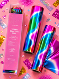 Two rolls of holographic reactive foil with a rainbow wave pattern and a pink branded box, styled on a pink glitter background with scattered diamond-shaped confetti.