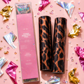 Two toner reactive foils with a pink box on a pink background with confetti and foil decorations.