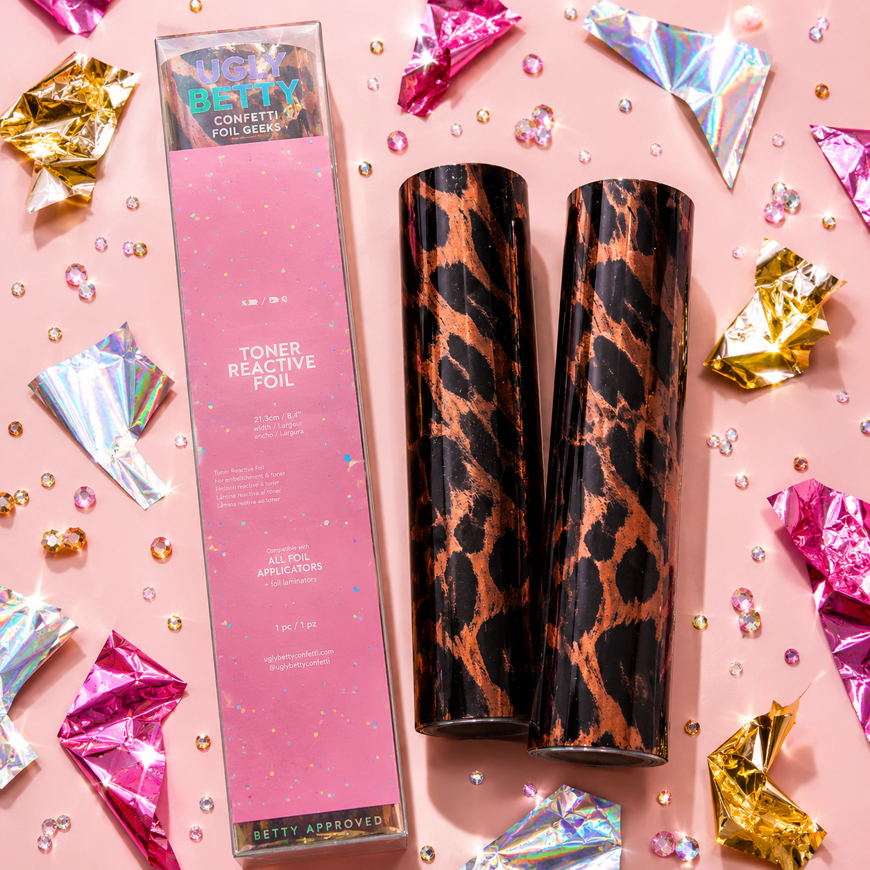 Two toner reactive foils with a pink box on a pink background with confetti and foil decorations.