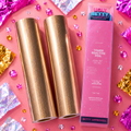 Gold foils and a pink packaging tube labeled 'Ugly Betty Confetti' on a pink background with confetti.