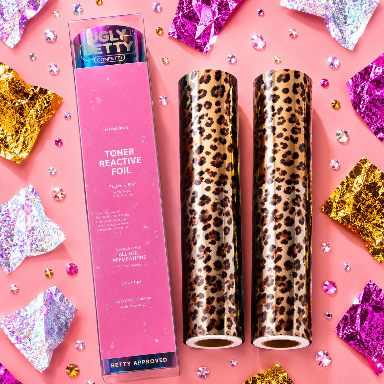Two leopard print toner reactive foils with a pink box labeled 'Ugly Betty' on a pink background with decorative confetti.