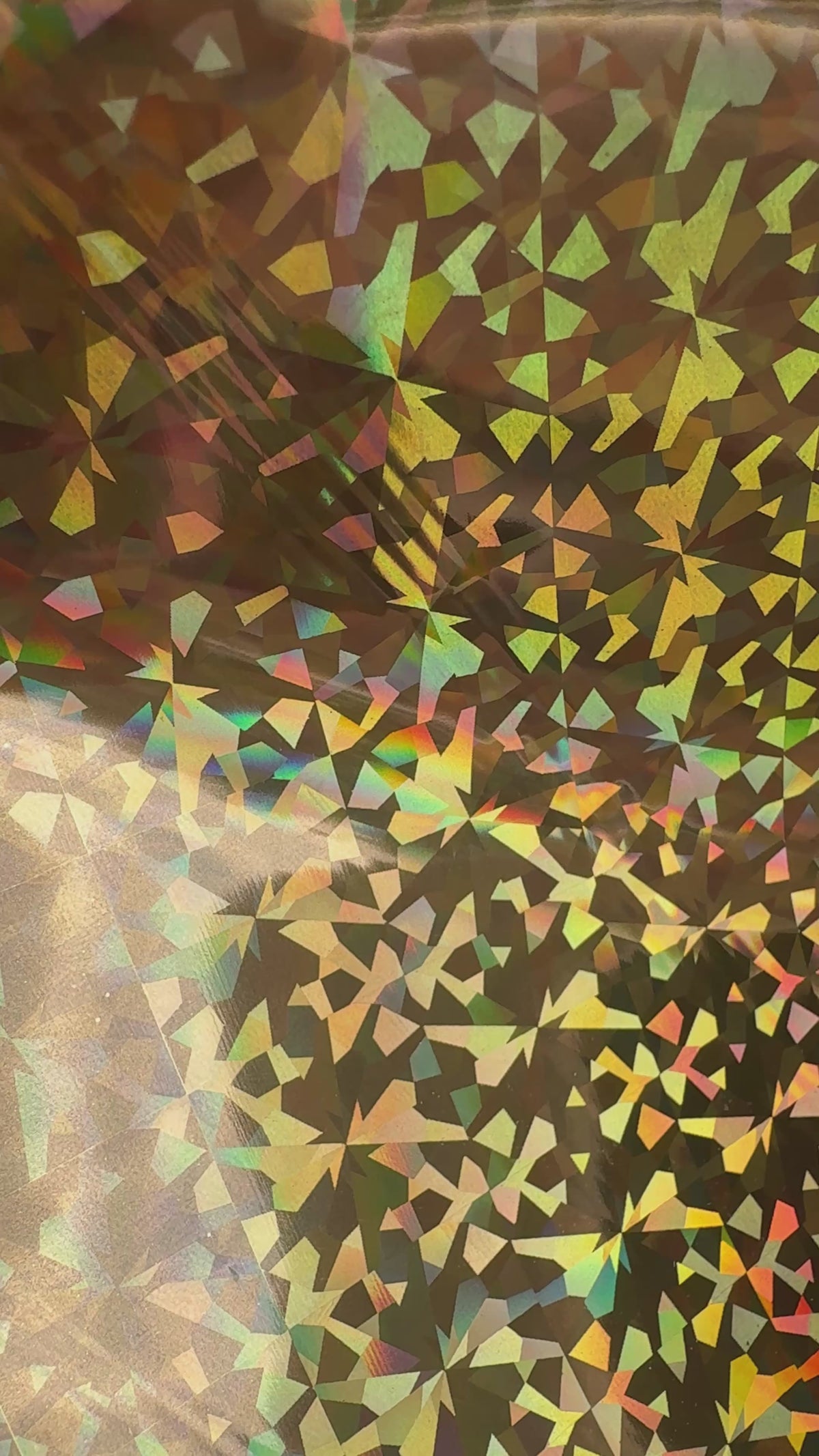 Crown Jewels gold prism holographic toner reactive foil tilting in the light, gold facets flashing rainbow