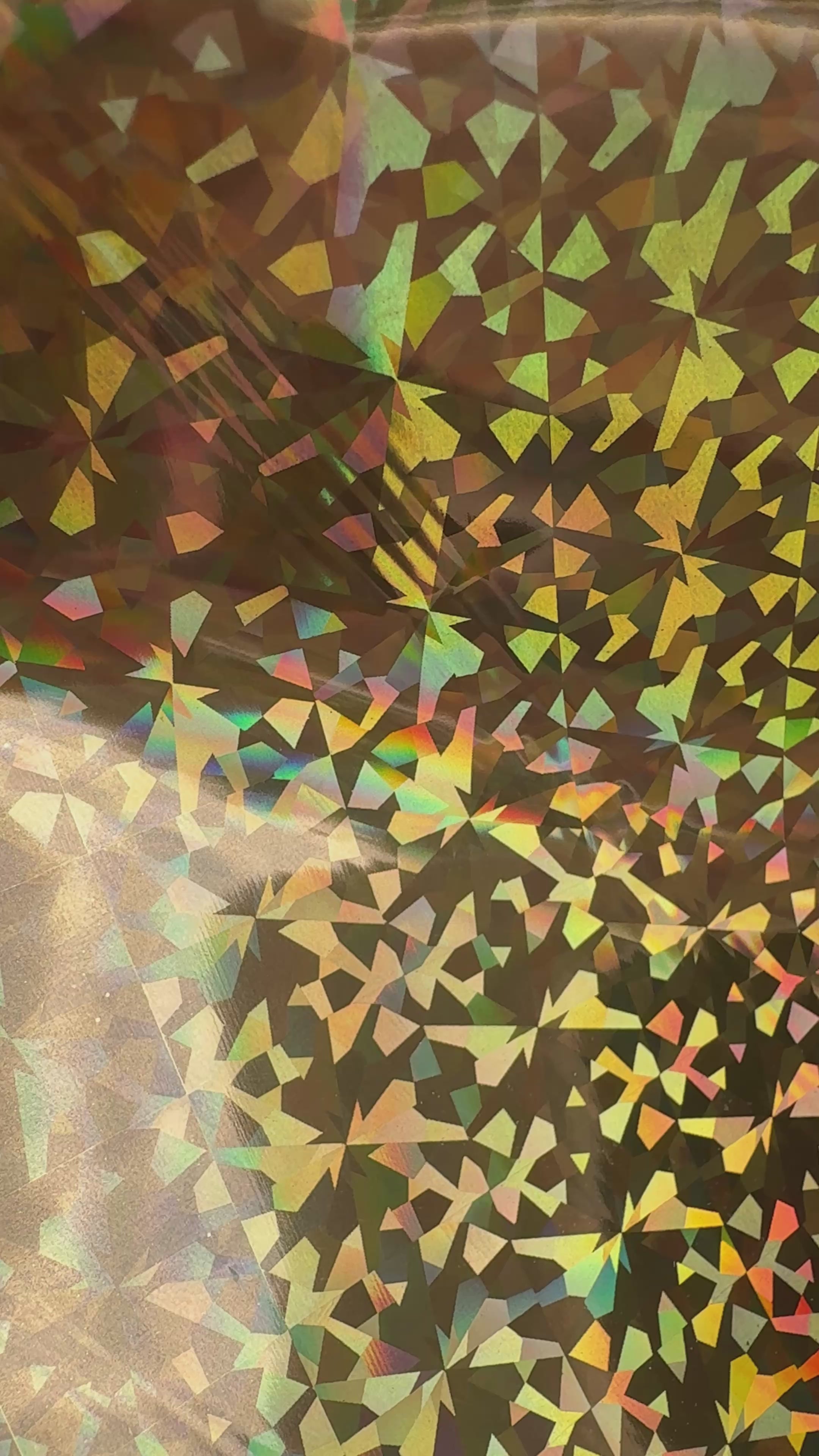 Crown Jewels gold prism holographic toner reactive foil tilting in the light, gold facets flashing rainbow