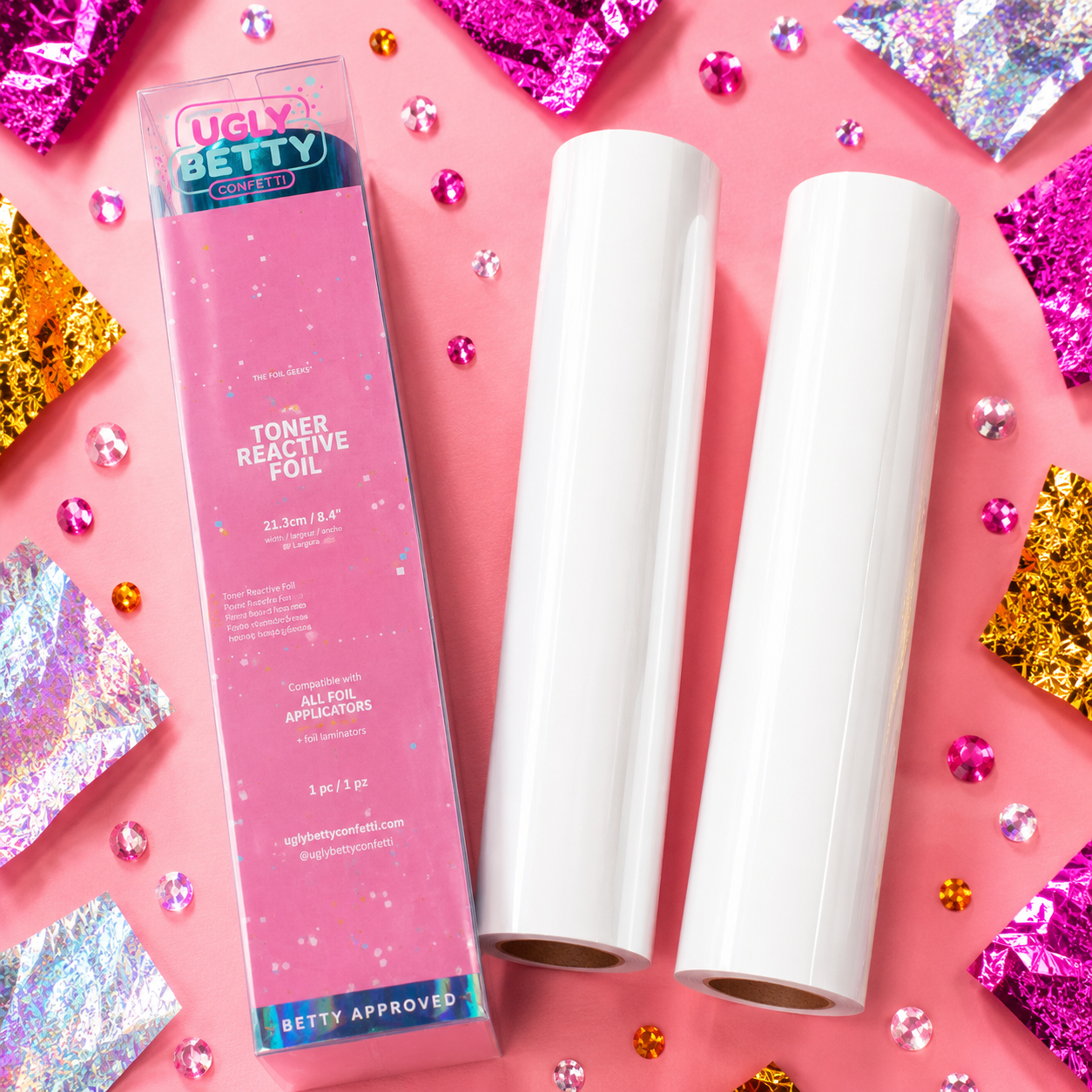 Ugly Betty toner reactive foil packaging with two rolls on a pink background with glitter.